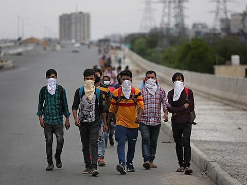 A group of Indian daily wage labourers walk along an expressway hoping to reach their homes, hundreds of kilometres away, as the city comes under lockdown in Ghaziabad, on the outskirts of New Delhi, India, on Thursday, March 26, 2020.