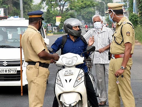Police personnel stop a commuter amid nationwide lockdown to control the spread of COVID-19 novel coronavirus, in Kochi on Wednesday.