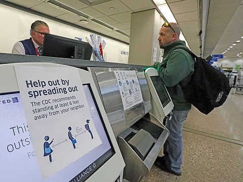 A sign is shown at the United ticketing counter at the Salt Lake City International Airport Wednesday, March 25, 2020, in Salt Lake City. Many airline flights are nearly empty as virus undercuts travel.