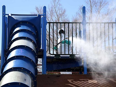 City of Las Vegas operations and maintenance staff worker Denis Connelly pressure washes playground equipment at Centennial Hills Park as part of an effort to keep the city's 70 parks open for the public during the coronavirus pandemic on March 25, 2020 in Las Vegas, Nevada. Picture used for illustrative purposes only.
