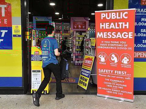 A man enters a pharmacy in Sydney on March 27, 2020, as people stay away due to restrictions to stop the spread of the worldwide COVID-19 coronavirus outbreak. The number of confirmed covid-19 cases in Australia passed the 3,000 mark on March 27, with the vast majority of infections in major east coast cities like Sydney, Brisbane and Melbourne.
