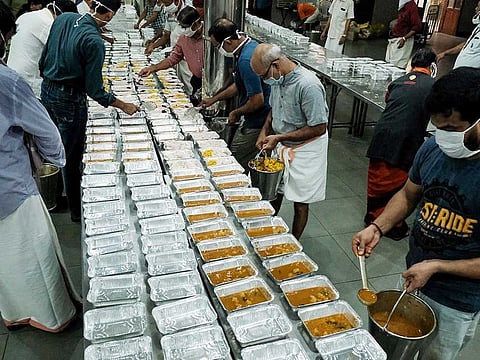 Volunteers pack food packets for migrant labourers on the third day of the lockdown announced due to coronavirus, in Kochi on Friday.