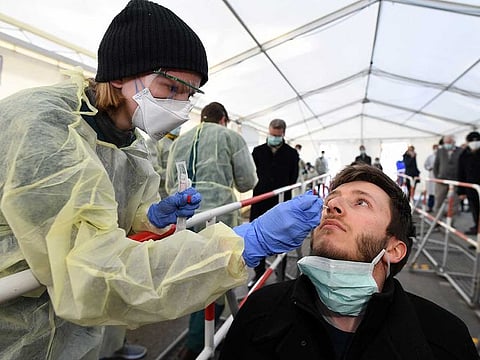 A medical employee presents how to collect a smear at a special corona test centre for public service employees such as police officers, nurses and firefighters during a media presentation as the spread of the coronavirus disease (COVID-19) continues, in Munich, Germany, on March 23, 2020.