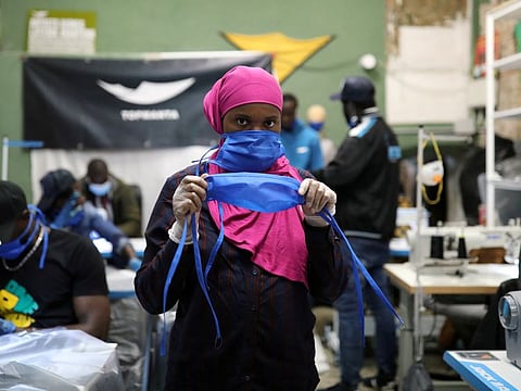 A manteros, member of the Popular Union of Street Vendors and the Top Manta brand, poses in a sewing workshop to produce gowns and masks for Catalan hospitals in the Raval neighbourhood, as the coronavirus disease (COVID-19) outbreak continues, in Barcelona, Spain March 28.
