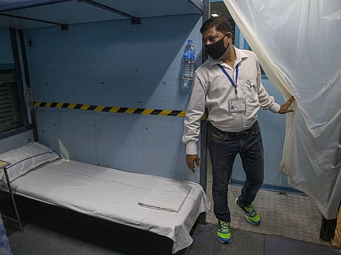 India railway employee Dipen Barman, inspects a train coach being converted into an isolation ward for the fight against the new coronavirus in Gauhati on March 29.