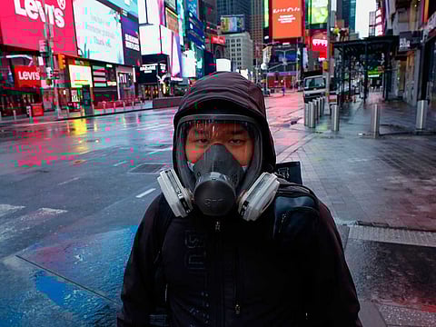 A man at the Times Square in in New York City on March 28, 2020. US President Donald Trump said on March 28, 2020 that he's considering a short-term quarantine of New York state, New Jersey, and parts of Connecticut.