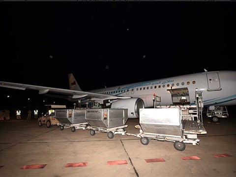 Containers of medical supplies arriving from China are being unloaded from a Royal Air Force of Oman plane.