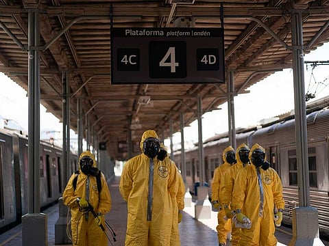 Soldiers stand in formation before disinfecting wagons for the new coronavirus at the central train station in Rio de Janeiro, Brazil, where trains connect cities within the state, on Thursday, March 26, 2020.