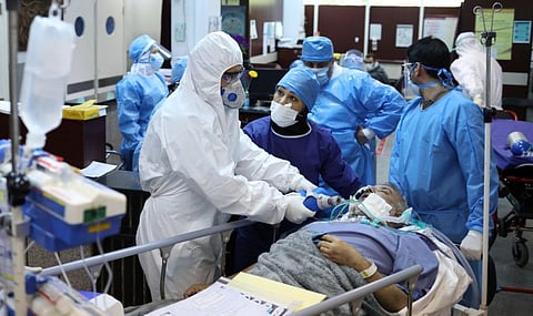 Emergency medical staff and nurses wearing protective suits, help while transferring a patient with coronavirus disease to Masih Daneshvari Hospital, in Tehran on March 30.