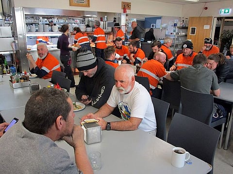 This handout photo taken in February 2019 and released on March 31, 2020 by the Australian Antarctic Division (AAD) shows expeditioners having a meal at the ADD's Casey Station in Antarctica. Inside Australia's four remote Antarctic research bases, some 89 people find themselves ensconced on the only COVID-19 coronavirus-free continent as they watch their old home transform beyond recognition.