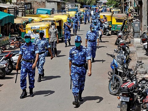 Members of Rapid Action Force (RAF) patrol a neighbourhood to urge people to remain indoors during a 21-day nationwide lockdown to slow the spreading of coronavirus disease (COVID-19), in Ahmedabad, India, April 1, 2020.