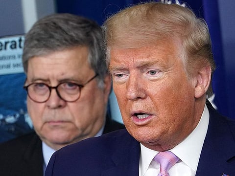 US President Donald Trump speaks, flanked by US Attorney General William Barr (L), during the daily briefing on the novel coronavirus, COVID-19, in the Brady Briefing Room at the White House on April 1, 2020, in Washington, DC.