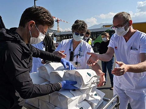 French chef Jean Sulpice (L) delivers sixty meals that he cooked at home for the medical staff of the Annecy hospital, on April 2, 2020 in Annecy, eastern France.