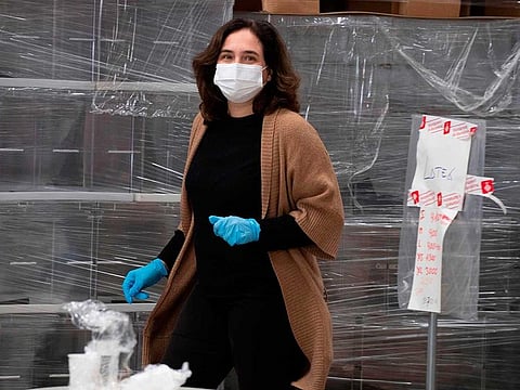 Barcelona mayor Ada Colau wearing a face mask arrives to give a press conference about the distribution of medical and sanitary material to public services in a warehouse of the Barcelona city council in Barcelona on April 2, 2020.