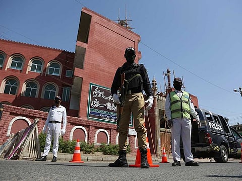 Police stand guard outside a mosque during a lockdown to help curb the spread of the coronavirus in Karachi, Pakistan, Friday, March, 3, 2020.