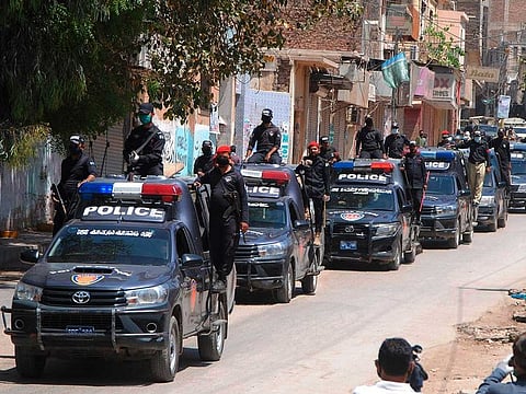 Police vehicles patrol during a government-imposed nationwide lockdown to try to contain the coronavirus, in Hyderabad, Pakistan, Thursday, April 2, 2020.