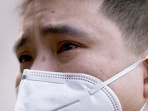 A man cries in Wuhan, Hubei province, as China holds a national mourning for those who died of the coronavirus disease (COVID-19), on the Qingming tomb-sweeping festival on April 4, 2020.