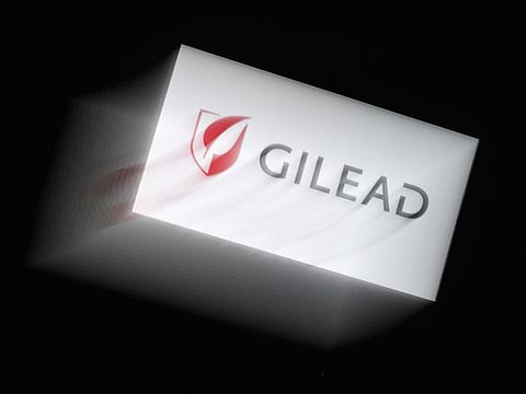 In this photo illustration a Gilead logo is displayed on a smartphone on March 25, 2020 in Arlington, Virginia. Gilead announced on March 25, 2020 that it has submitted a request to the Food and Drug Administration to rescind the exclusive marketing rights it had secured for remdesivir, an antiviral drug that shows promise in treating Covid-19, the disease caused by the new coronavirus.