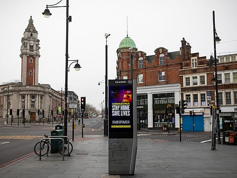 A U.K. government-issued advisory reading "Stay Home, Save Lives" sits on display in the Brixton district of London, U.K., on Saturday, April 4, 2020. The U.K. reported its deadliest day yet, with an increase of 708 coronavirus deaths, bringing the total to 4,313