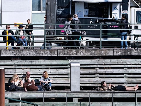 People relax in the sun, as the spread of the coronavirus disease (COVID-19) continues, in Malmo, Sweden earlier this month