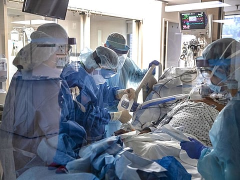 A doctor tends to a patient suffering from the coronavirus COVID-19, in the Surgical Intensive Care Unit of the hospital, in New York