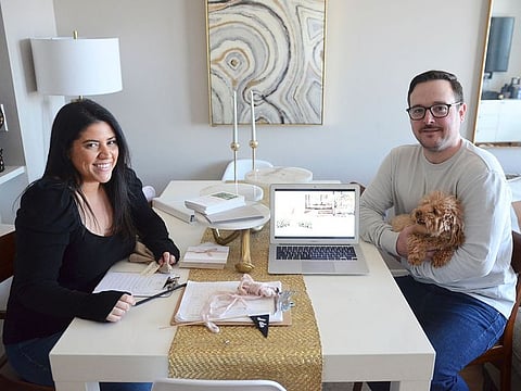 Karina L. Lopez, left, poses with her fiance Curtis Rogers and their dog Fifi at their home in the Long Island City section of the Queens borough of New York.