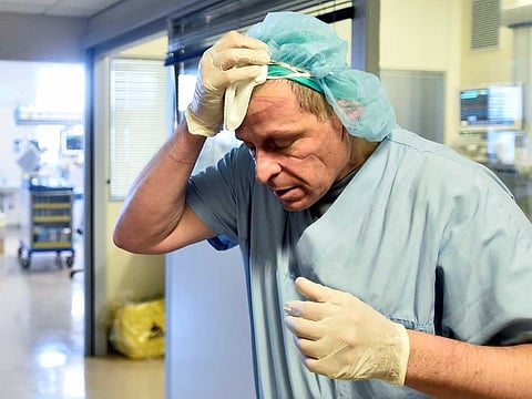 A medical staff member reacts in the intensive care unit, where patients suffering from the coronavirus disease (COVID-19) are treated, at the Circolo hospital in Varese, Italy April 9, 2020.