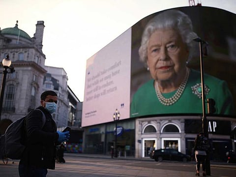 An image of Queen Elizabeth II and quotes from her historic TV broadcast commenting on the coronavirus epidemic are displayed at Piccadilly Circus in London, Wednesday April 8, 2020.