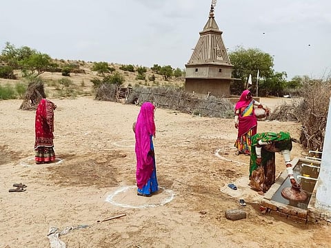 Women maintain social distancing at a water facility in Tharparkar, Pakistan