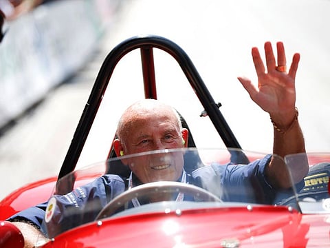 Stirling Moss waves to spectators as he from his 1955 Ferrari 750 Monza during the Ennstal Classic rally near the Austrian village of Groebming in 2013.