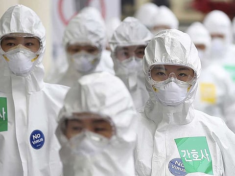 Medical staff members arrive for a duty shift at Dongsan Medical Center in Daegu, South Korea.