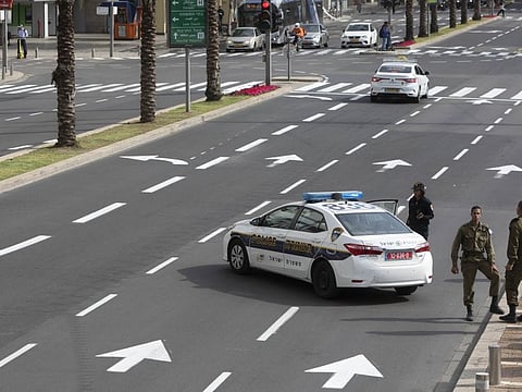 Israeli regime soldiers stand with police officers at a roadblock near Rabin square in Tel Aviv. Mossad has used international contacts to avert shortages that might have overwhelmed Israel’s health system in the fight against COVID-19.