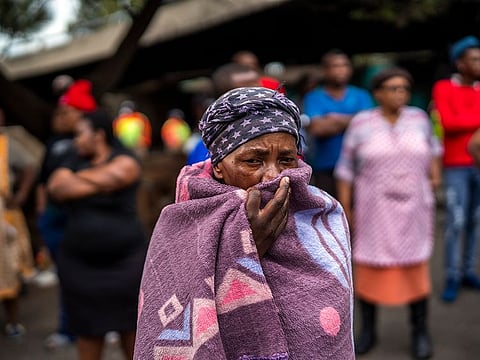 People living near the traditional medicine market wait to receive food baskets from private donors, Monday, April 13, 2020 downtown Johannesburg.
