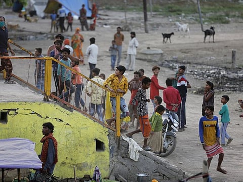 Indian homeless people running away from the bridge on seeing the police doing patrolling during lockdown to control the spread of the coronavirus in Prayagraj, on April 13.