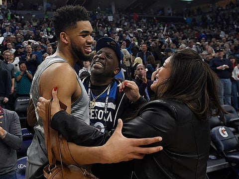 Karl-Anthony Towns of the Minnesota Timberwolves hugs his parents, Karl and Jackie Towns