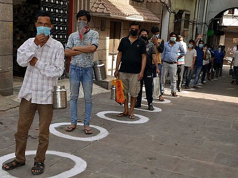 People keep social distance while standing in a queue to purchase milk during coronavirus lockdown, in Mathura, India. Many countries have managed to put a lid on COVID-19 even as the worldwide infections surged past 9.24 million. But some of those countries, which were thought to have been free of the virus, are reporting a resurgence in cases.