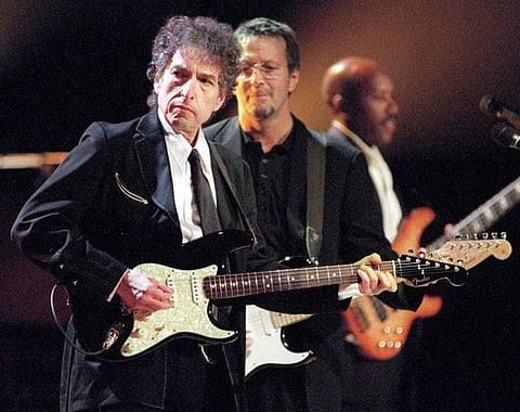 TO GO WITH STORY SLUGGED: BOB DYLAN--FILE--Rock and Roll legends Bob Dylan, left, and Eric Clapton, center, perform for a sold out crowd at New York's Madison Square Garden, in this June 30, 1999, file photo. In his fourty-year career, Dylan has released 43 albums and sold over 50 million recordings. (AP Photo/John Bellissimo/HO)