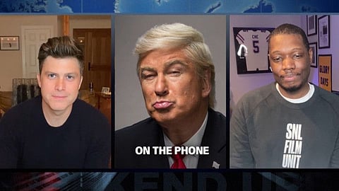 New York: In this screengrab provided by NBC, from left to right, anchor Colin Jost, Alec Baldwin as Donald Trump, and Michael Che perform the Weekend Update during "Saturday Night Live" which aired on Saturday, April 11, 2020. For the first time in its lengthy history, "Saturday Night Live" held an all-quarantine version, with stars delivering taped material primarily from their homes. AP/PTI(AP13-04-2020_000003B)