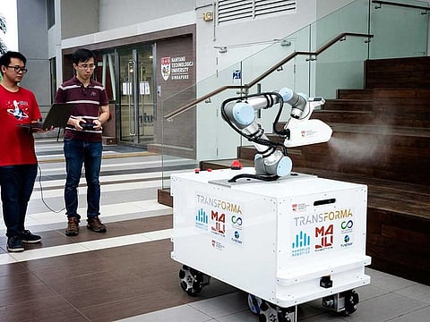 This undated handout from the Nanyang Technological University (NTU) Singapore released on April 15, 2020 shows the eXtreme Disinfection roBOT (XDBOT), a semi-autonomous robot which can be used to clean and disinfect surfaces, in Singapore. Singapore researchers have invented a disinfecting robot with an arm that mimics human movement, to help take the load off overworked cleaners during the coronavirus pandemic.