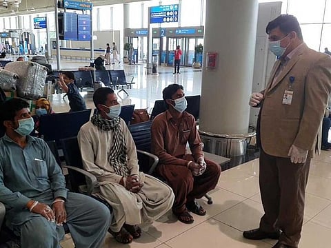 Pakistan Consul General in Dubai Ahmed Amjad Ali talking to passengers who flew from Dubai Airport on a special PIA flight to Islamabad last month. File photo