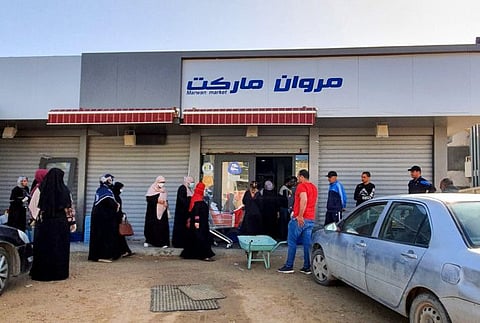 Libyans queue outside a super market, during a curfew announced in the capital Tripoli on April 19. Already tired by the tribulations of war, Libyans in the capital Tripoli are reluctant to respect lockdown measures.