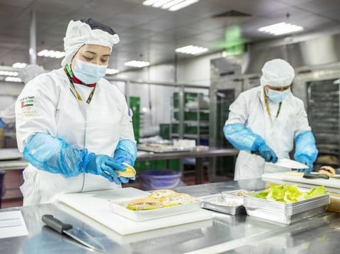 EAS Catering Chefs preparing food boxes for humanitarian distribution