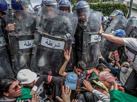Students scuffle with riot police during an anti-government demonstration in Algiers, Algeria, on 21 May 2019. Photo by Farouk Batiche, of Deutsche Presse-Agentur, which won first prize in the Spot News Singles category and was also nominated for the World Press Photo of the Year.