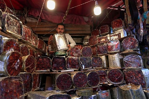 A Yemeni vendor stacks boxes of date in the old city market of the capital Sana'a ahead of Ramadan on April 18.