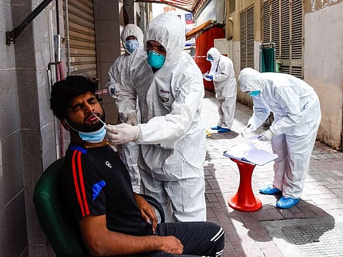 Healthcare workers conduct coronavirus testing in Dubai's Naif district
