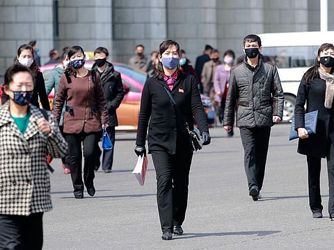 Pedestrians wear face masks to help prevent the spread of the new coronavirus in Pyongyang, North Korea.
