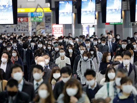 People wear face masks at Shinagawa station during the rush hour after the government expanded a state of emergency to include the entire country following the coronavirus disease (COVID-19) outbreak