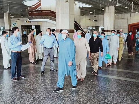 Passengers arriving in Islamabad being taken to quarantine facility.