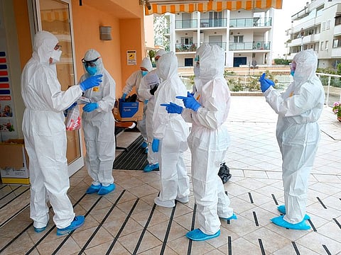 Volunteer doctors prepare to administer swabs at a nursing home in Santa Marinella, near Rome, Tuesday, April 21, 2020.