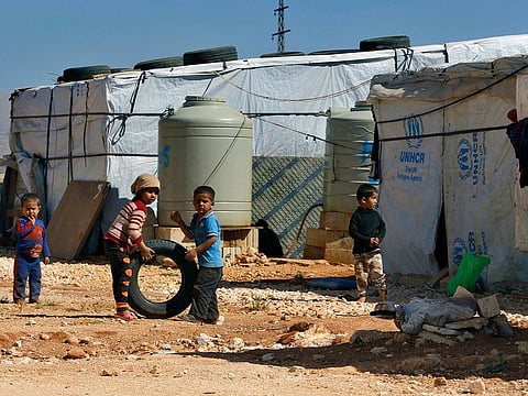 Syrian refugee children play outside their family tents at a Syrian refugee camp in the eastern city of Baalbek, Lebanon. The U.N. agency for Palestinian refugees said Wednesday, April 22, 20202, that a Palestinian woman from Syria living in a refugee camp in Lebanon has become the first refugee to test positive for the coronavirus.